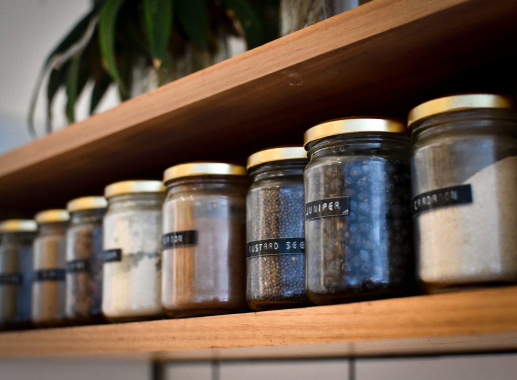 Spices in jars as a part of their small pantry organization.