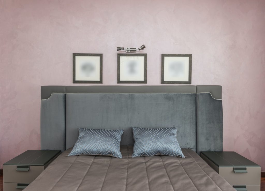 A picture of a queen size bed with two night stands indicating the importance of symmetry for a cozy minimalist home.